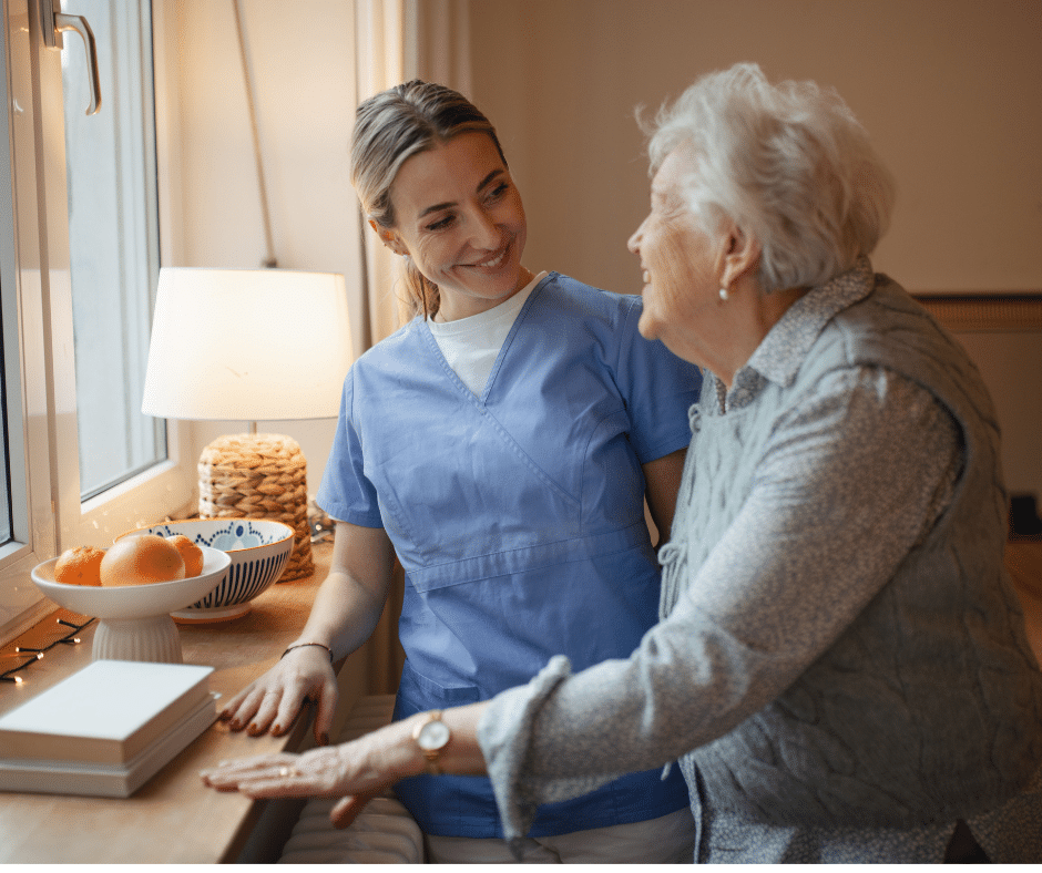 caregiver and senior smile to each other
